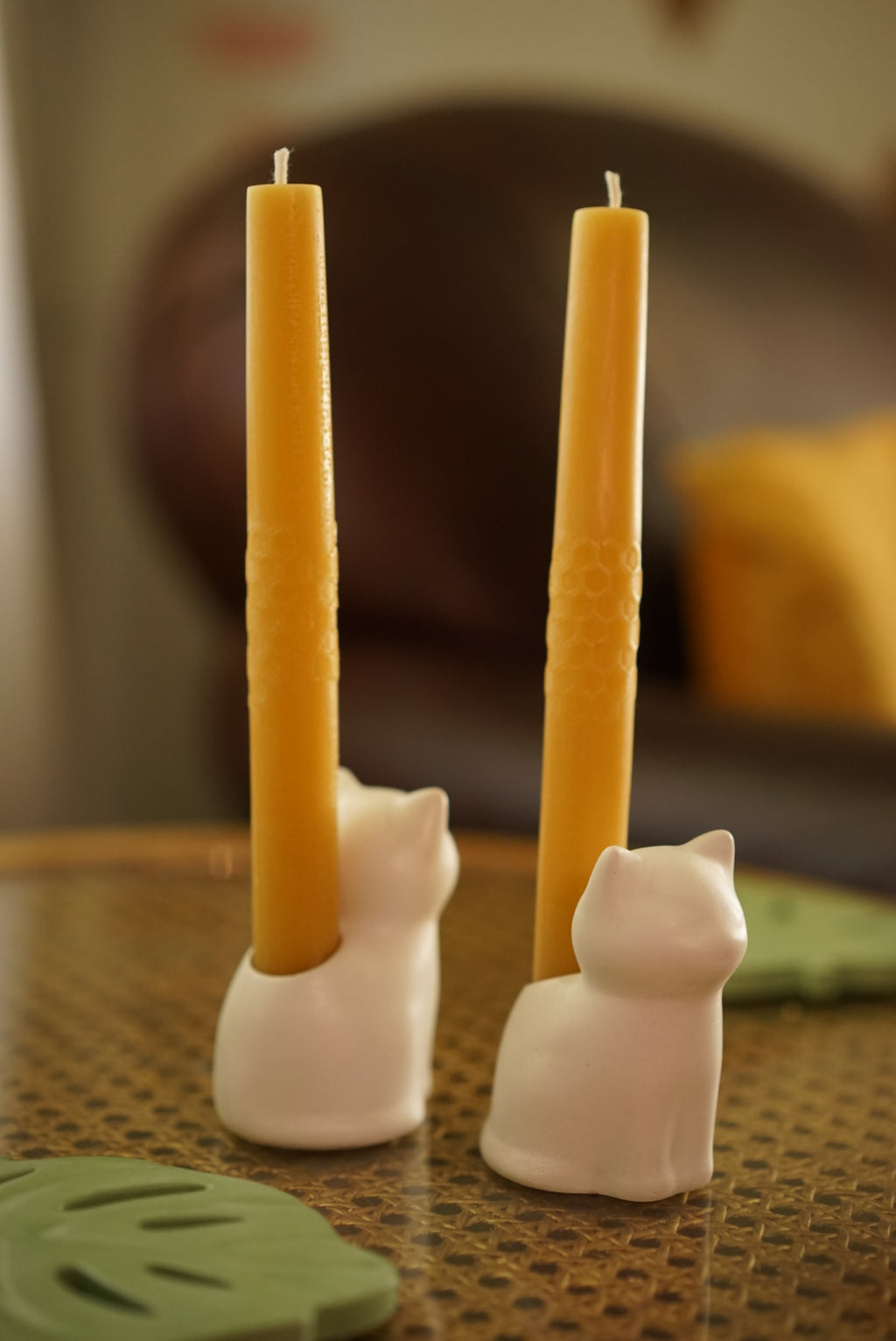 Adorable kitten-shaped candle holders in white cement. With pure beeswax candles with honeycomb design.