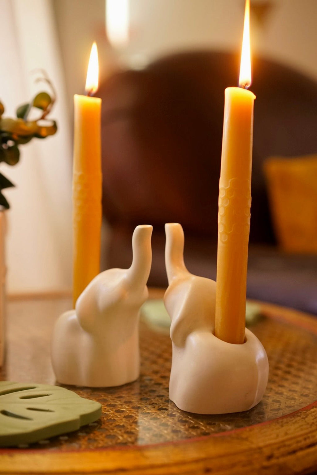 White elephant ceramic candle holders holding pure beeswax candles by Case Peck