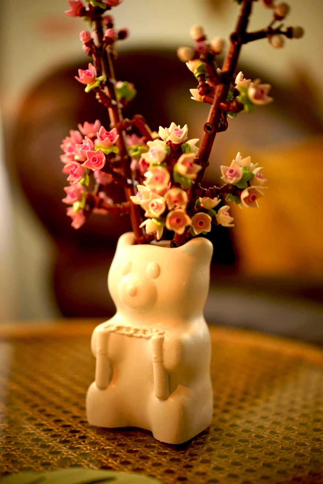Side view of Ceramic vase shaped like a Nunchuck holding bear holding lego flowers by Case Peck